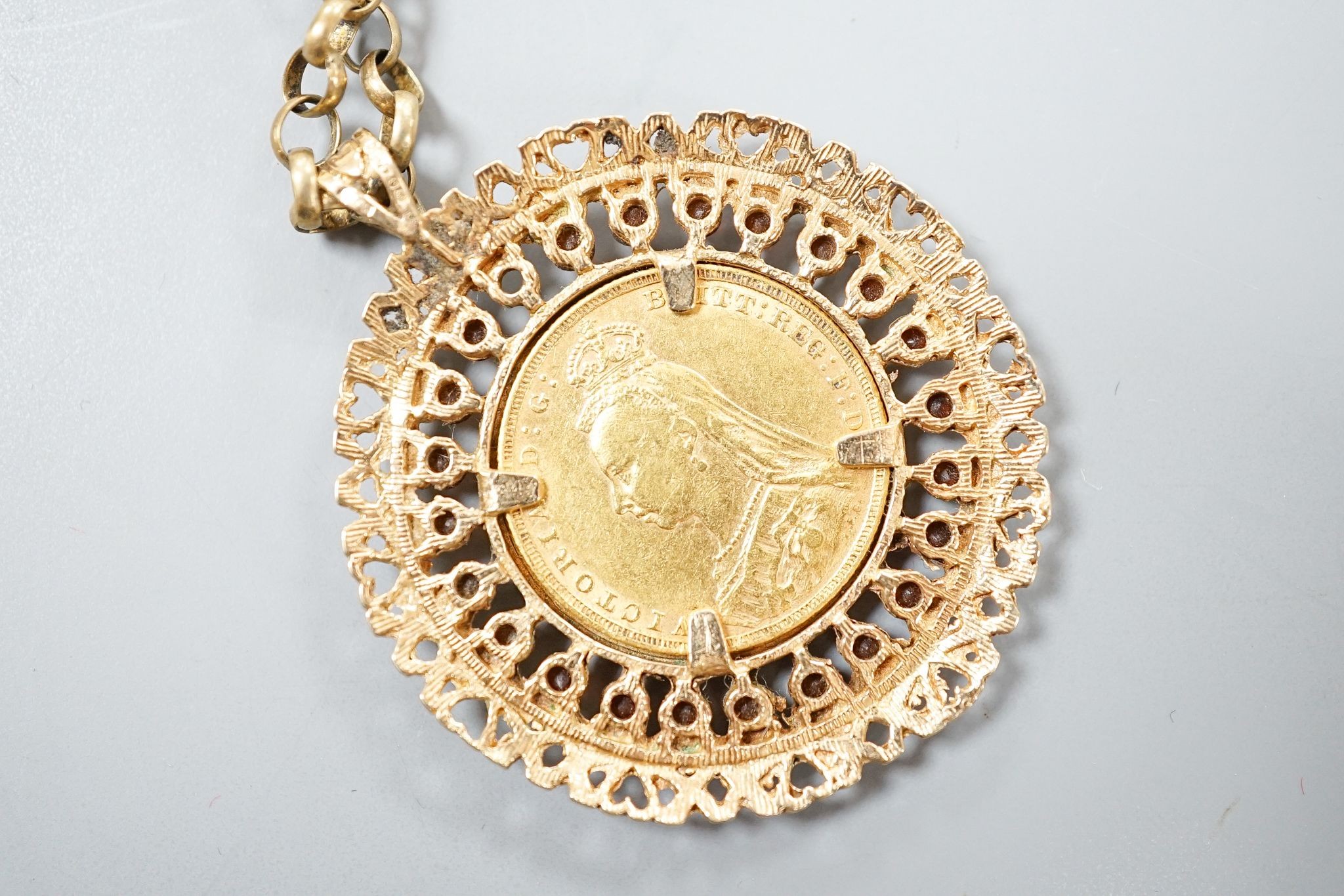 An 1892 gold sovereign, in a 9ct gold and garnet? set pendant mount on a 9ct gold chain, gross weight 29.2 grams.